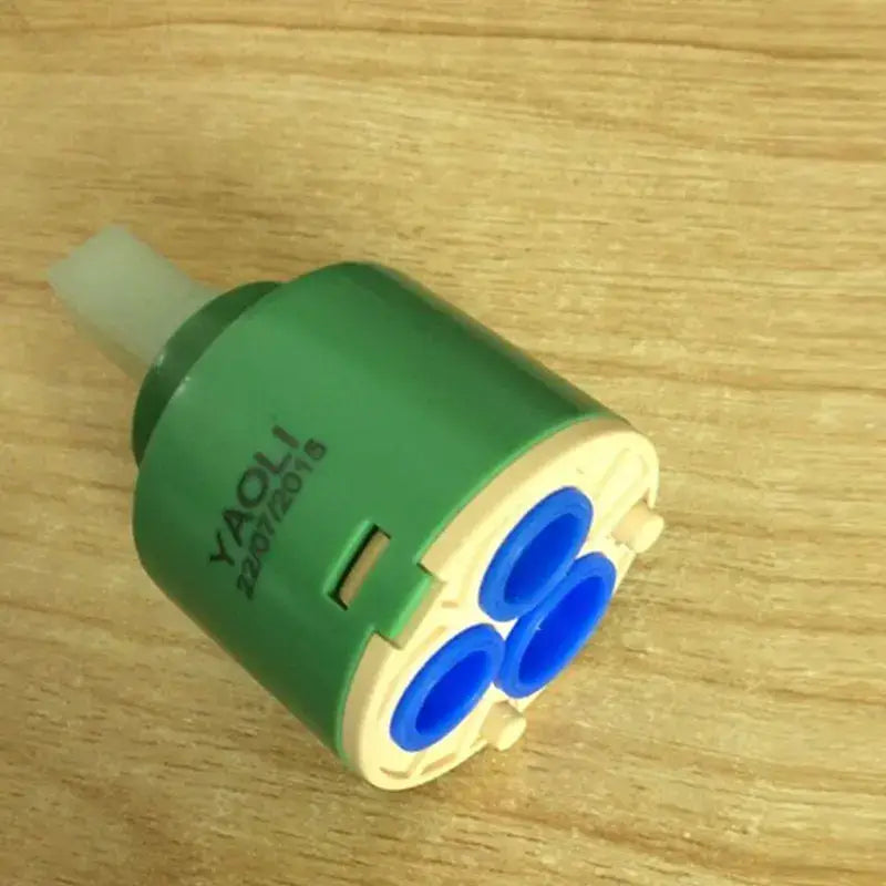 Green and beige 40mm ceramic faucet cartridge with three blue internal openings for kitchen valve replacement