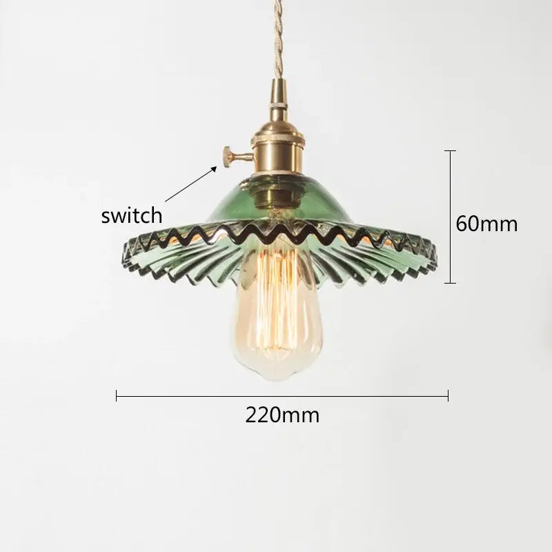 Green and clear glass pendant light with an exposed filament bulb and decorbites copper base for dining room decor