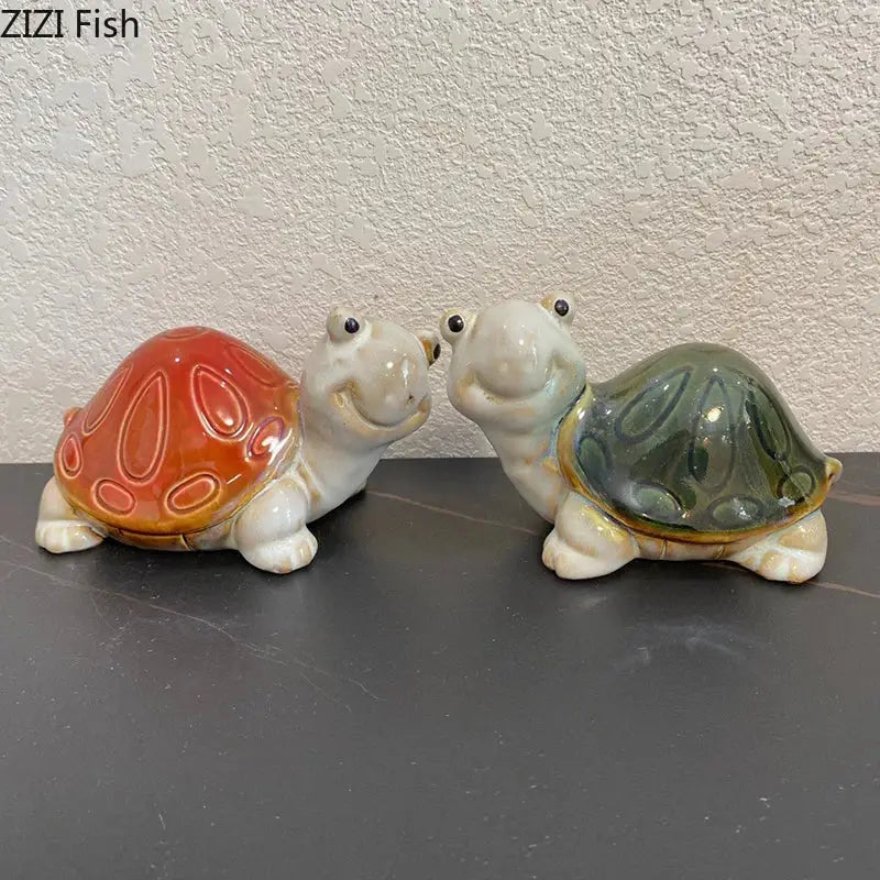 Green and cream ceramic cute turtle statue tray featuring two smiling ceramic turtle statues with orange and greenish-blue shells