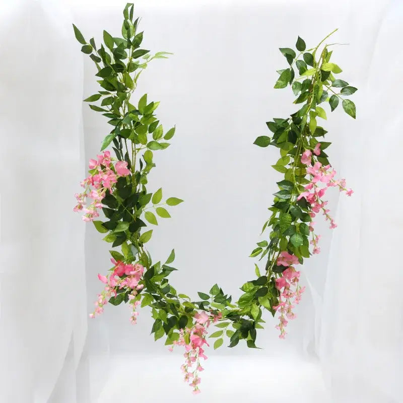Green and white artificial flowers garden wedding arch decor with delicate pink blossoms and synthetic vine leaves by decorbites artificial flowers