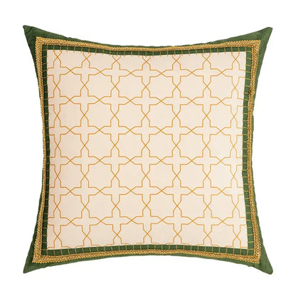 Square cushion cover with cream fabric, gold geometric tufted embroidery, and green border with golden braided trim from decorbites