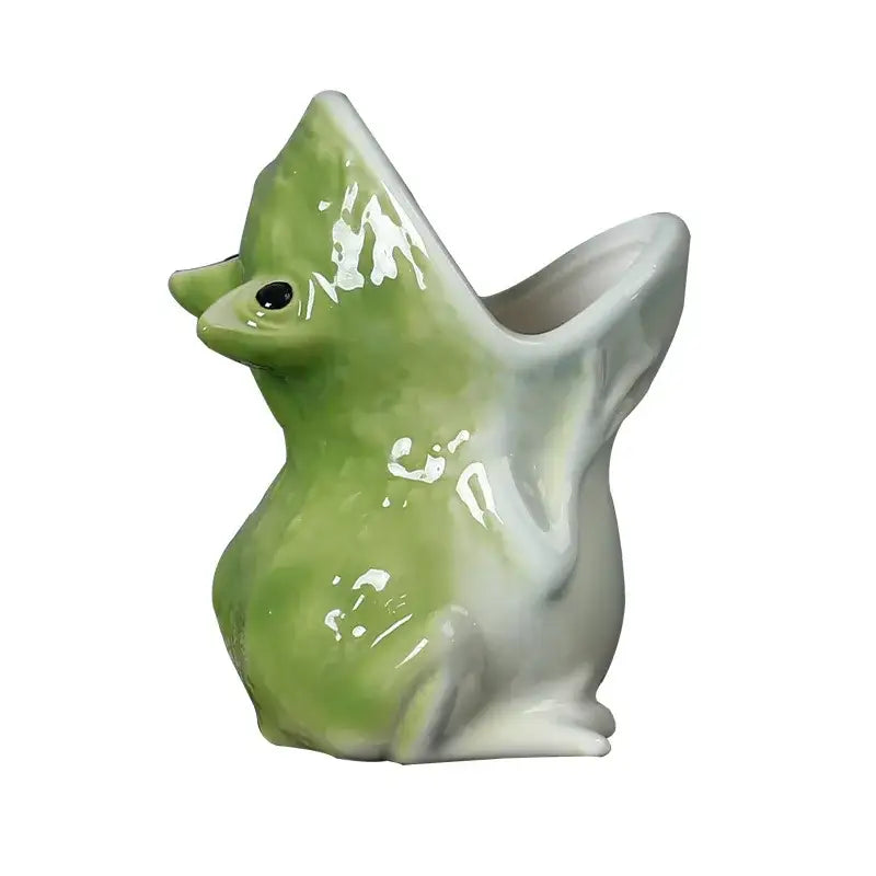 A glossy green and white ceramic duck flower pot with a wide open beak complementing decorbites cute frog decor