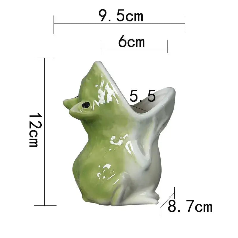 A glossy green and white ceramic sitting duck figurine with an open beak for decorbites cute frog succulent flower pot decor