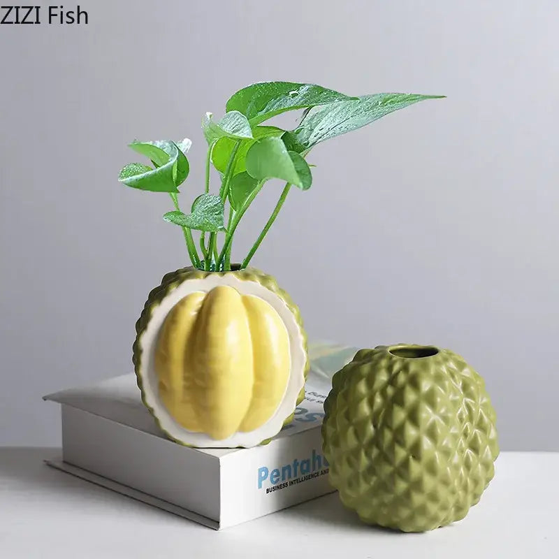 Green and yellow durian ceramic vase with textured rind design for living room decor featuring a yellow interior