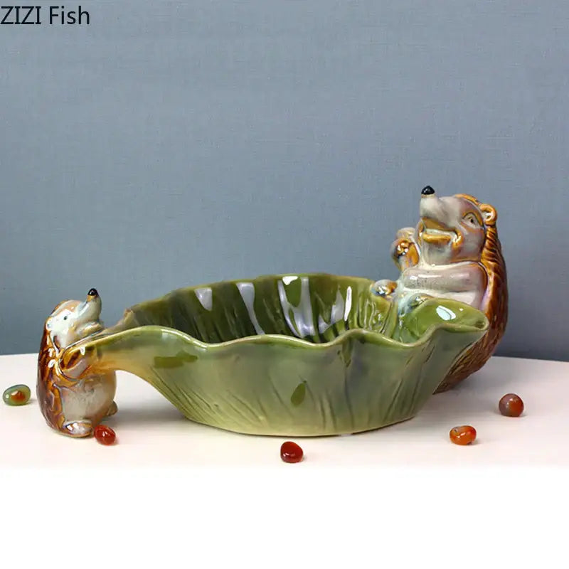 Green ceramic leaf decor tray featuring two porcupine figurines for dining room storage by decorbites ceramic leaf