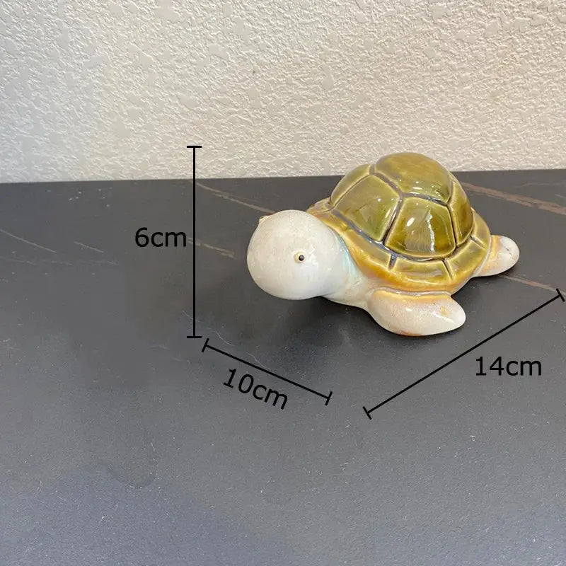 Green ceramic turtle statue with a glossy olive-green shell and white body for desk decoration or bedroom trinket dish