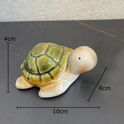Green ceramic turtle statue desk decoration with yellow and beige shell and black detailing for bedroom trinket dish