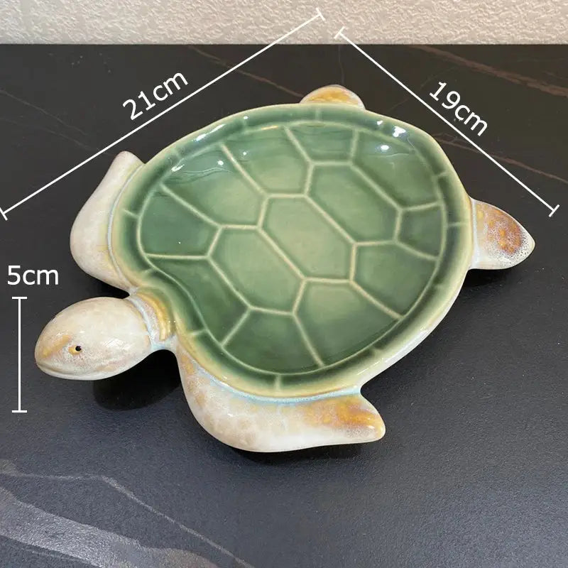 Green ceramic turtle statue desk decoration with glossy shell and cream limbs for bedroom trinket dish use