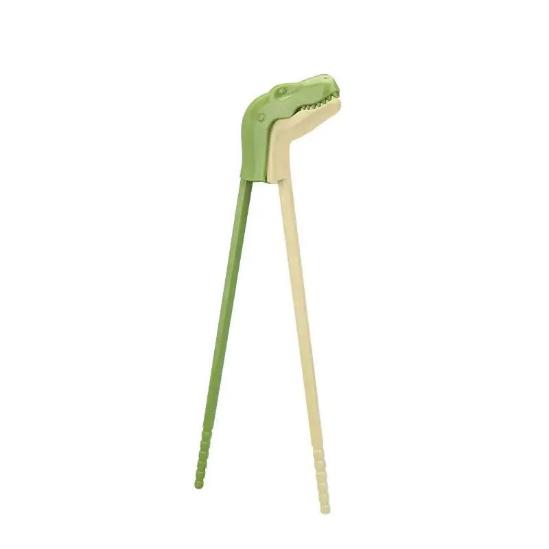 Green and beige dinosaur shaped dino chopsticks with textured handles for kids training by decorbites