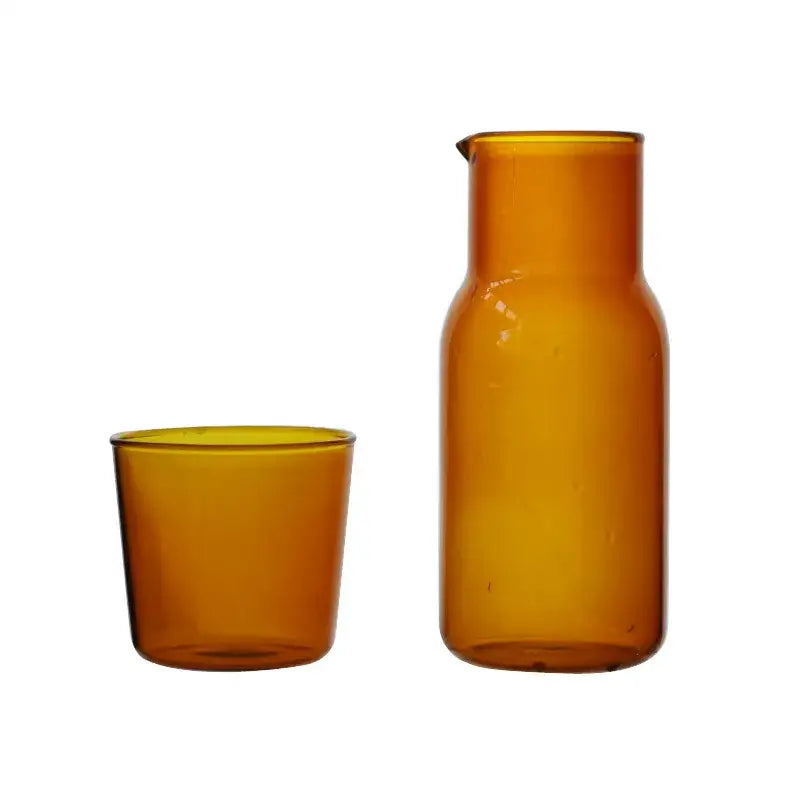 Amber-colored glass carafe with narrow spout and rounded body in 550ml bedside water carafe set for bedroom use