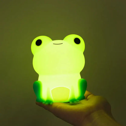 Green silicone frog night light made of smooth plastic with black eyes and a simple smile for bedroom decorbites frog night