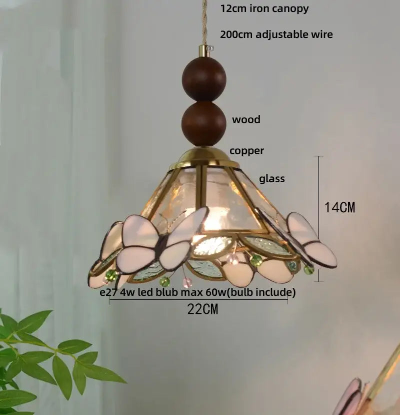 Green stained glass butterfly pendant light featuring clear glass led panels, copper frame, and wooden top beads decorbites