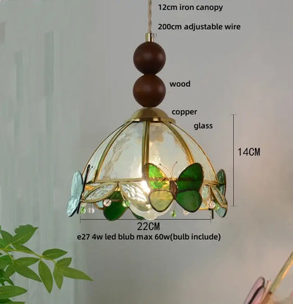 Green stained glass butterfly pendant light featuring brass-finished copper frame decorbites clear glass panels