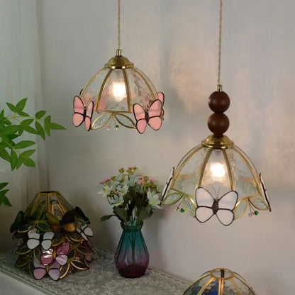 Two hanging stained glass pendant lights with pink and white butterfly motifs brass accents decorbites clear glass led
