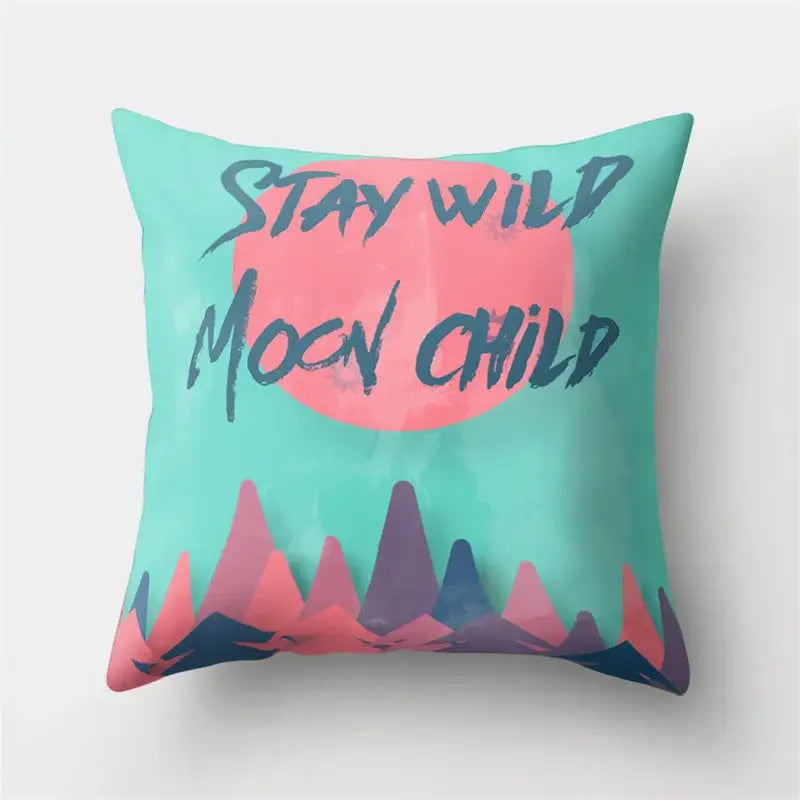 Teal throw pillow with pink circular design and stay wild moon child text, perfect for decorbites green tropical leaves forest decor
