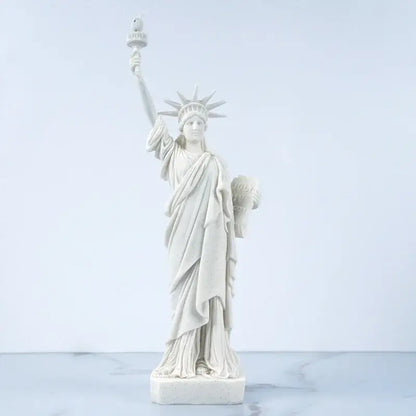 White marble liberty statue model with detailed drapery and raised torch for office desk decor by decorbites