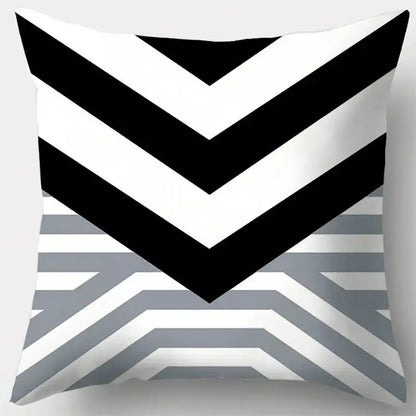 A square pillow case with a bold black and white chevron pattern transitioning into grey geometry stripes for living room decor
