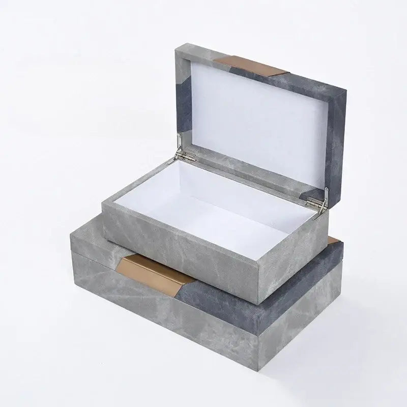 Gray textured jewelry container with grey marble pattern leather, gold-tone accents, and white interior for desktop organization