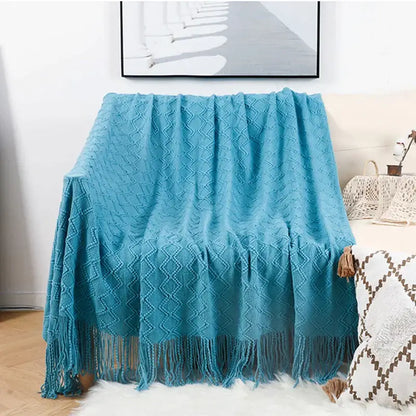 A cozy turquoise knitted throw blanket with diamond pattern and tassels for decorbites grey nordic waffle knit decor