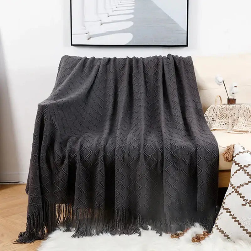 Dark gray knitted throw blanket with diamond pattern and fringe in grey nordic waffle knit decorbites grey nordic style