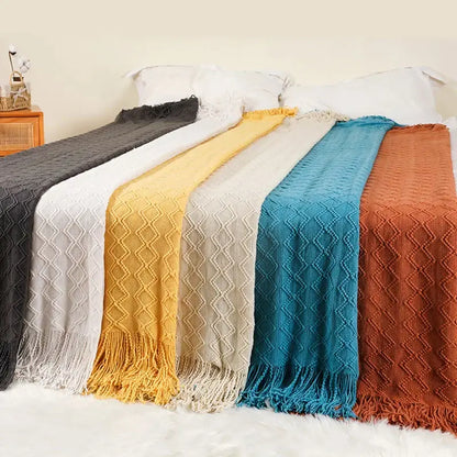 Six colorful knitted throw blankets in nordic waffle knit with diamond patterns including decorbites grey nordic