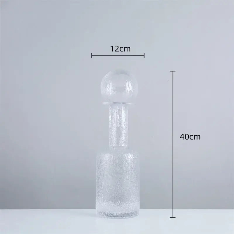 Clear glass decanter with textured frosted finish and rounded spherical stopper in decorbites grey round glass vase set with hammer lid