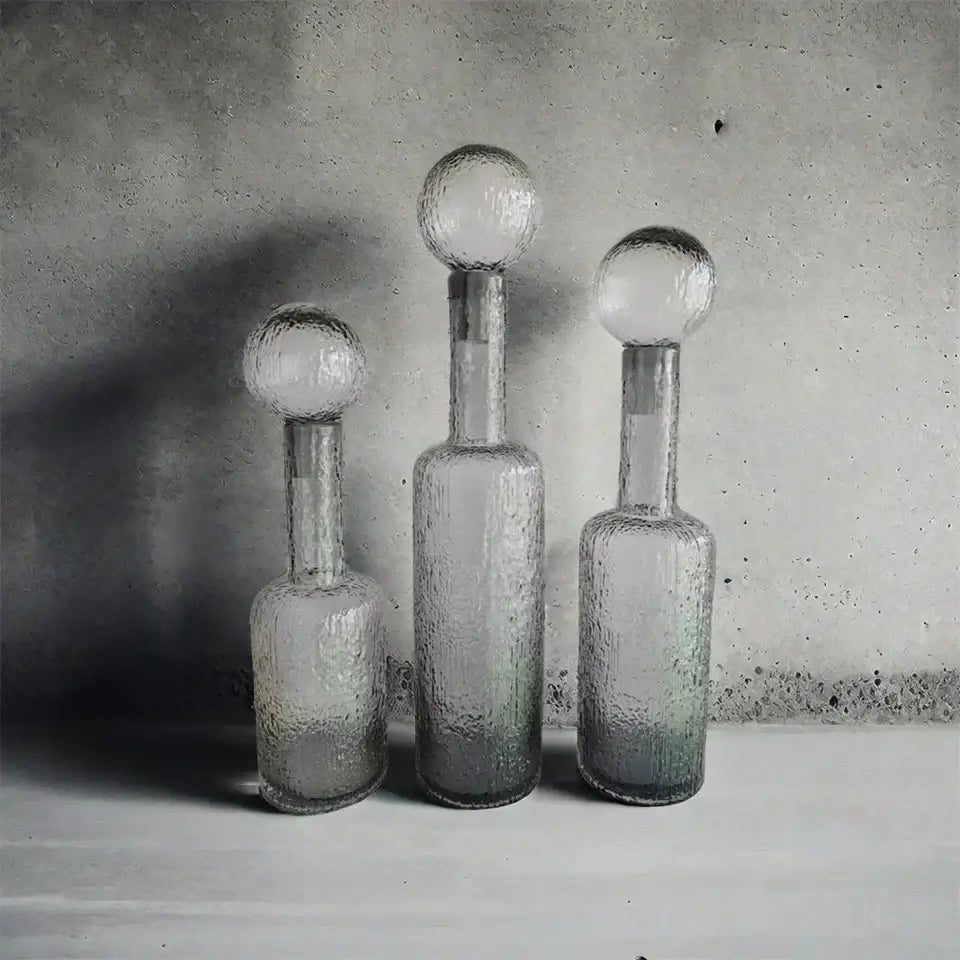 Three textured grey round glass decanters with frosted spherical hammer lid stoppers for living room decorbites decor
