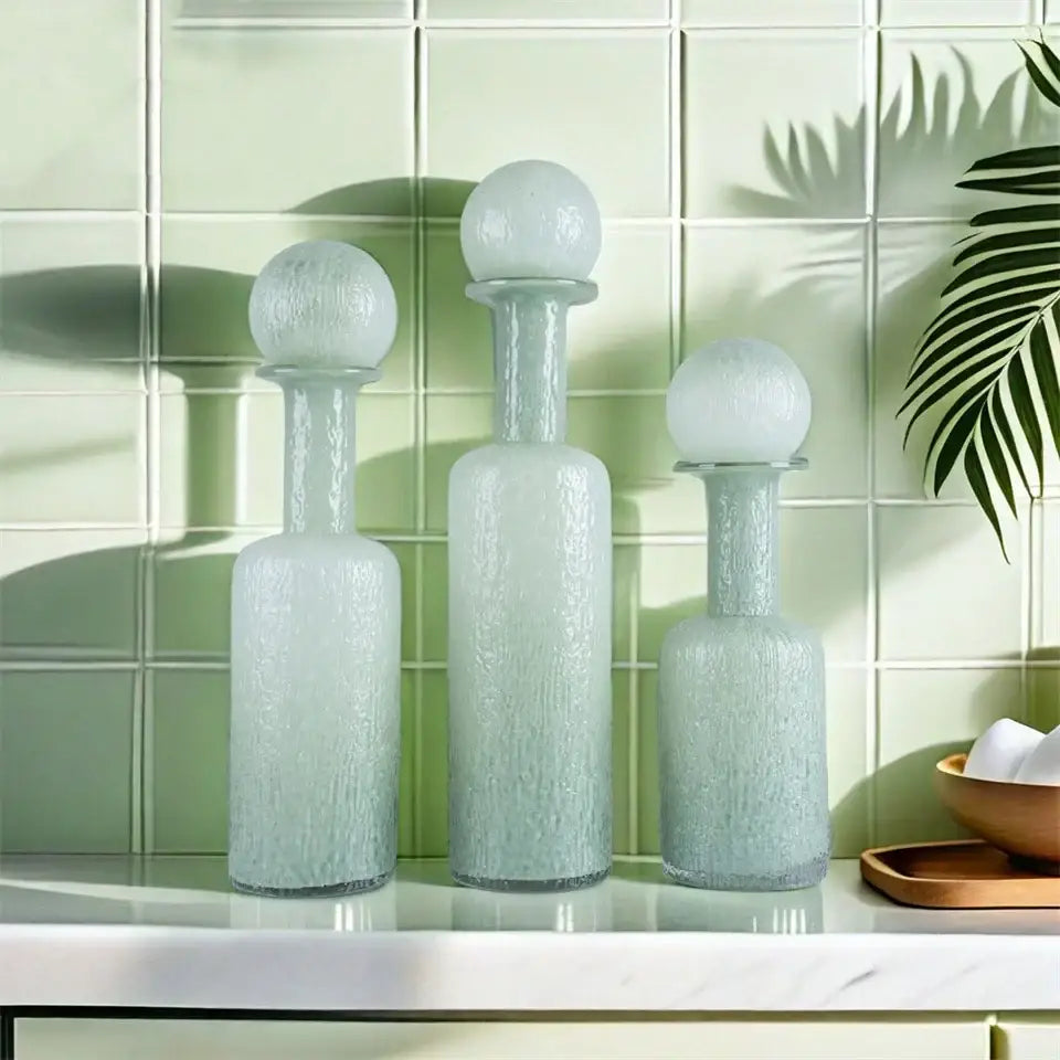 Three frosted grey round glass decanters with hammer lid stoppers and textured surfaces for living room decorbites decor