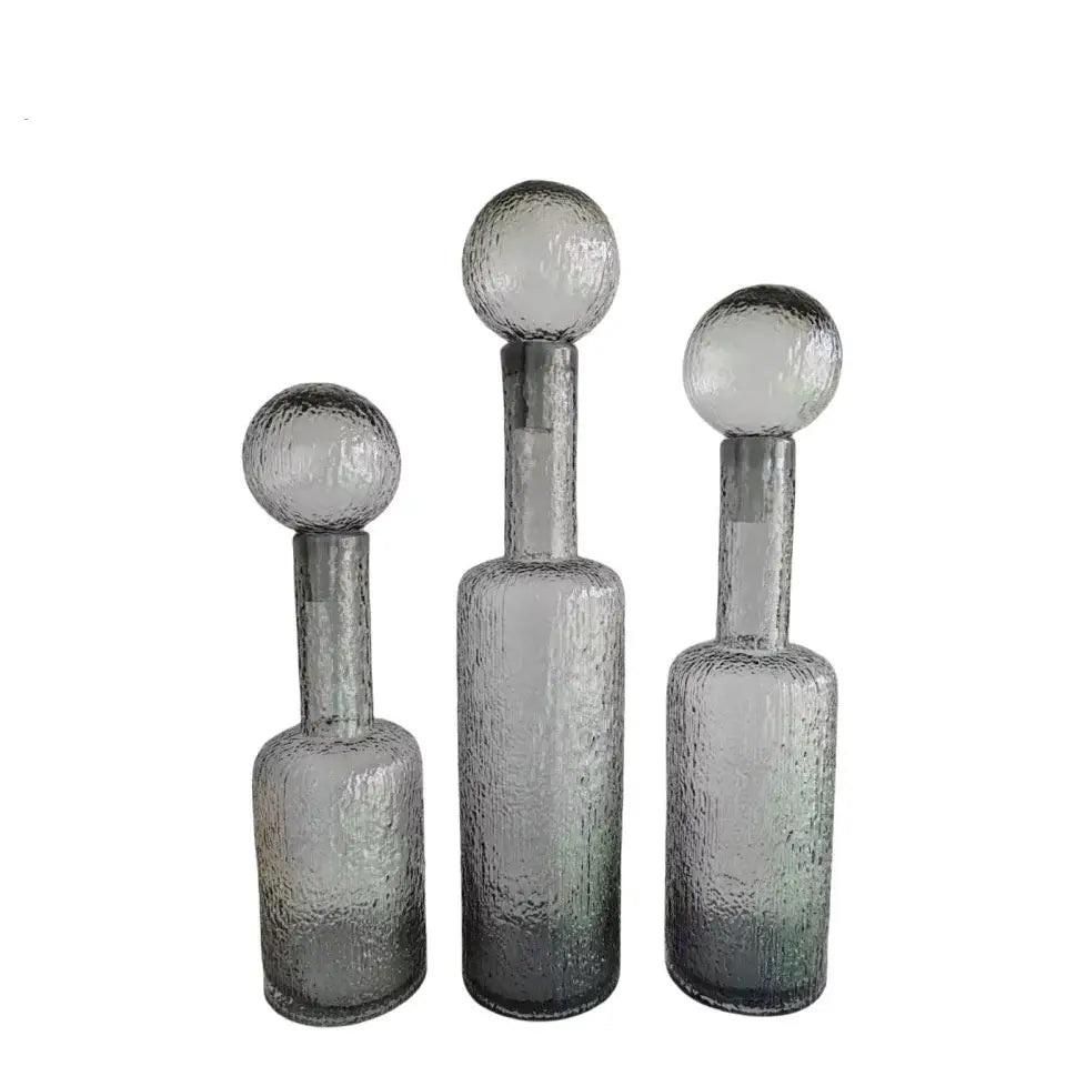 Set of three grey round glass vases with hammer lid stoppers featuring textured grey round glass decorbites design