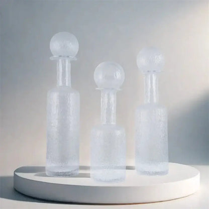 Three frosted grey round glass vases with hammer lid stoppers and textured surface for living room decorbites decor