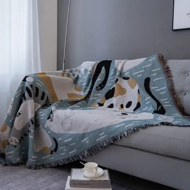 A soft light blue halloween style tassel throw blanket with colorful cartoon cats and pumpkin bedroom decor design