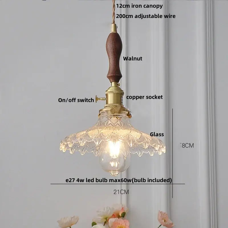 Vintage-style pendant light with walnut handle brass hardware and ornate amber glass led scalloped shade for kitchen