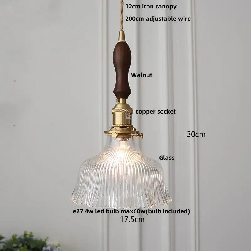 A clear ribbed glass pendant light with brass copper socket and dark walnut canopy for amber glass led lighting