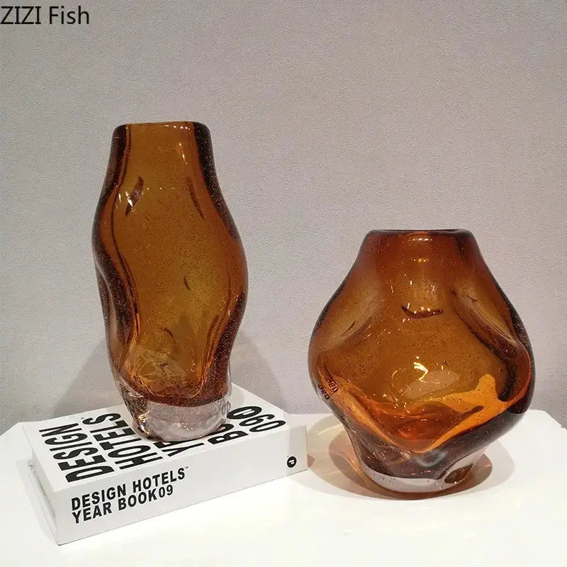 Two amber glass vase decorbites hand blown with textured surfaces and artificial flower desk decor on white surface
