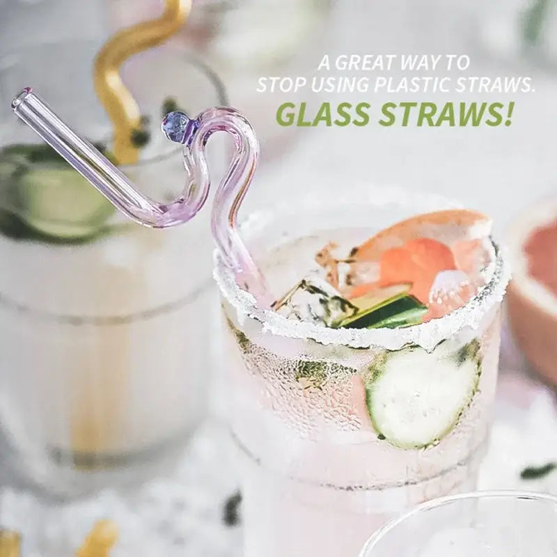 A delicate lavender hand blown decorbites glass straw with a curved swan design and blue accent for drinkware use
