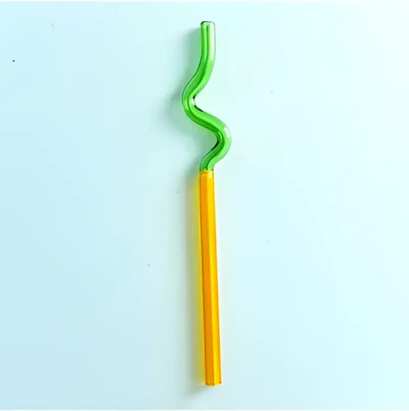 A vibrant yellow and green hand blown colorful twisted glass straw from decorbites glass straws kitchen set