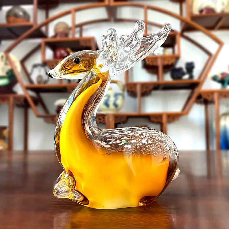 Hand blown glass sika deer figurine in translucent amber with clear antlers and speckled brown back for living room decor