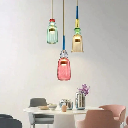 Three colorful hand blown textured glass pendant lights in pink green and blue for kitchen accent lighting