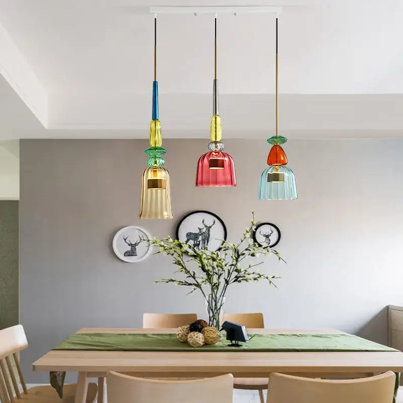 Three colorful hand blown textured glass pendant lights hanging from the ceiling for kitchen accent lighting