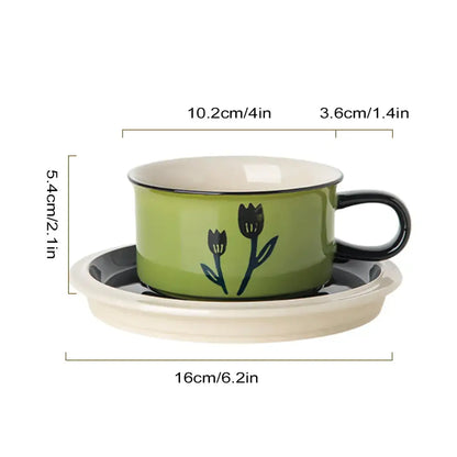 Green ceramic espresso cup with hand-drawn black tulip design and matching saucer dining room set