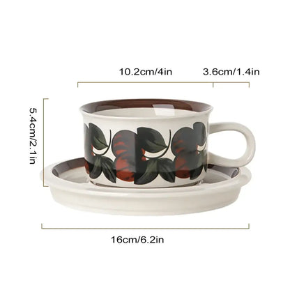 White ceramic espresso cup with brown rim and black and red fruit pattern paired with matching saucer dining set