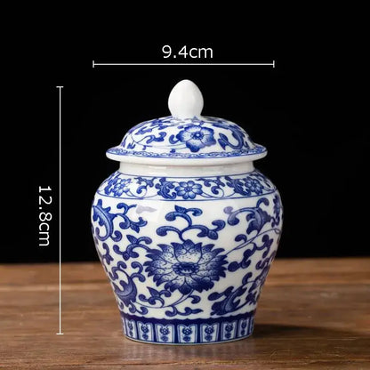 Hand-painted floral white porcelain tea canister with intricate blue patterns and matching lid for kitchen storage