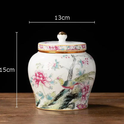 Hand-painted floral white porcelain tea canister with gold-trimmed lid featuring pink peonies and colorful birds design