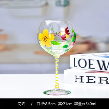 Hand-painted floral wine goblet featuring vibrant yellow red and green flowers with a striped stem by decorbites crystal