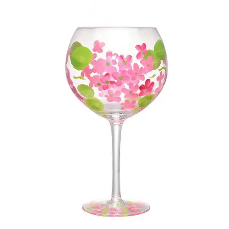 A clear glass floral wine goblet hand-painted with pink flowers and green leaves by decorbites crystal