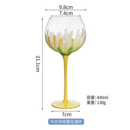 Hand painted glass goblet with yellow stem and base featuring white and yellow daisy petals for dining room decor