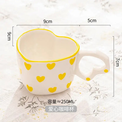 White ceramic love mug with hand painted heart handle yellow heart patterns and matching yellow rim kitchen set