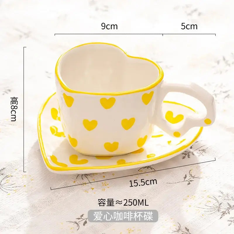 White ceramic love mug and saucer set with hand painted heart handle and yellow polka dots for 250ml capacity