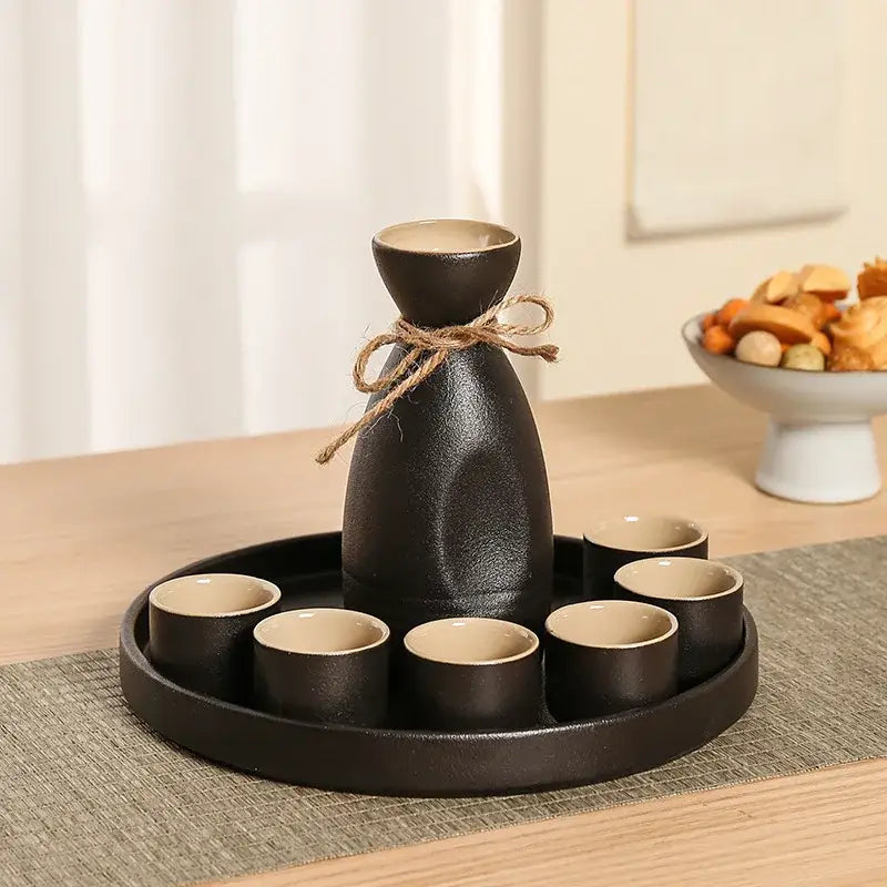 Handcrafted decorbites black ceramic wine warmer sake set with beige interior bottle and six cups on circular tray for dining room