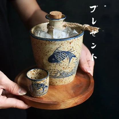 Handcrafted blue fish speckled beige ceramic wine set with matching cup on wooden tray for dining room use